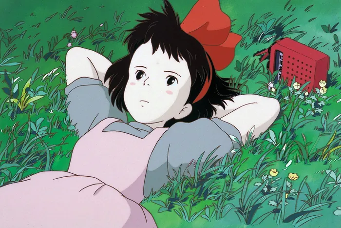 A young girl in a modest gray dress and pink apron lays face up on a grassy hillside, arms behind her head as the wind softly blows and her little red radio plays relaxing music.