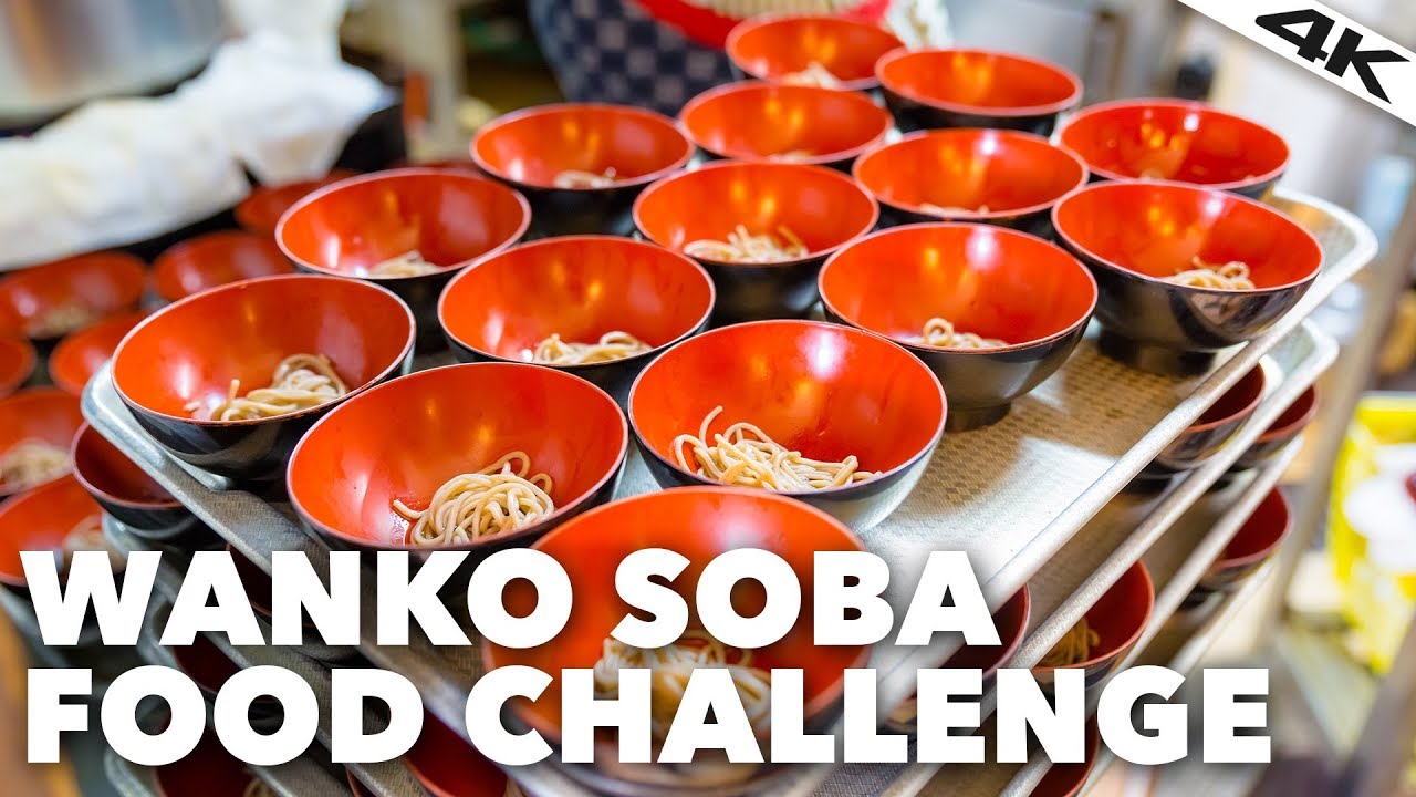 Trays stacked 4 high with  shallow bowls of soba